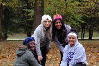 Diverse group of students show off a newly planted tree